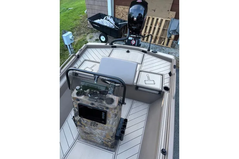 Slide: The Image of 2025 Thor Lake Hammer boat interior with camouflage console and outboard motor. - 12