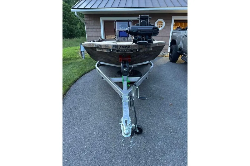 Slide: The Image of 2025 Thor Lake Hammer boat on trailer in driveway, ready for transport. - 4