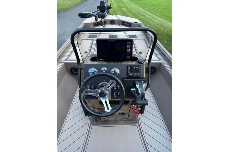 Slide: The Image of 2025 Thor Lake Hammer boat dashboard with steering wheel and navigation controls. - 5