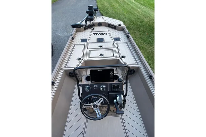 Slide: The Image of 2025 Thor Lake Hammer boat interior with modern dashboard and steering wheel. - 7