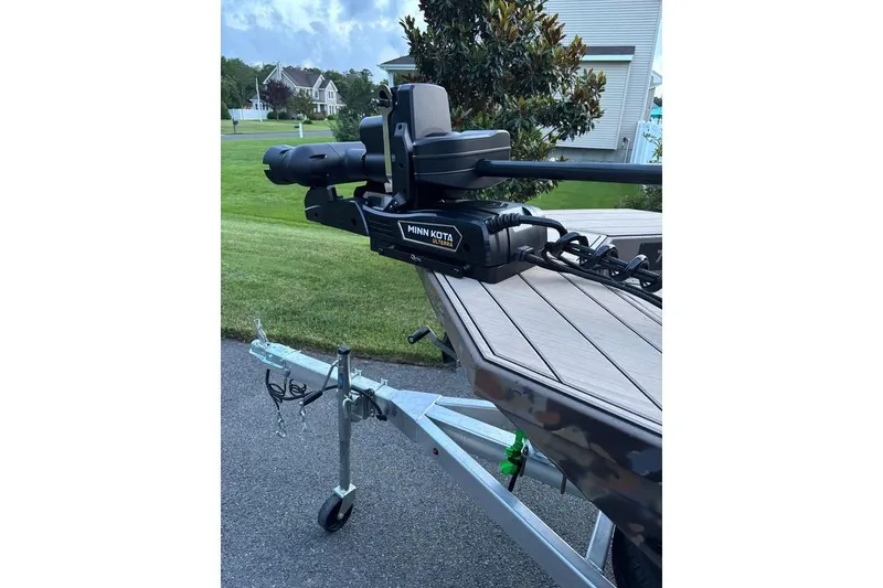 Slide: The Image of Boat trailer with Minn Kota motor, Thor Lake Hammer 2025 model, parked on a driveway. - 8
