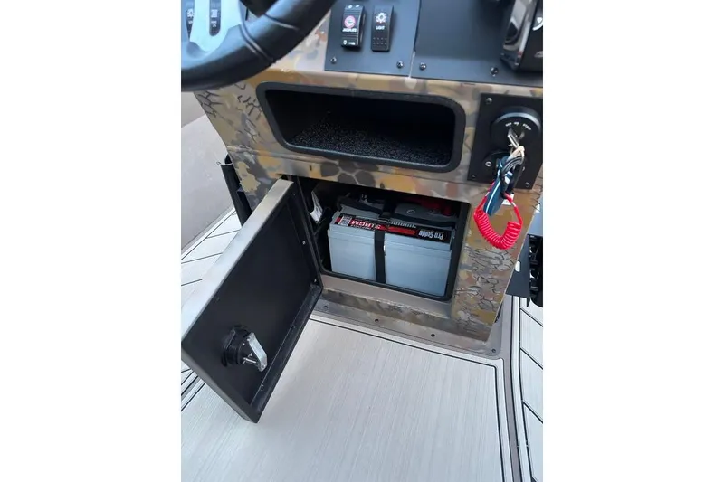 Slide: The Image of Control panel of 2025 Thor Lake Hammer boat with battery compartment open. - 9
