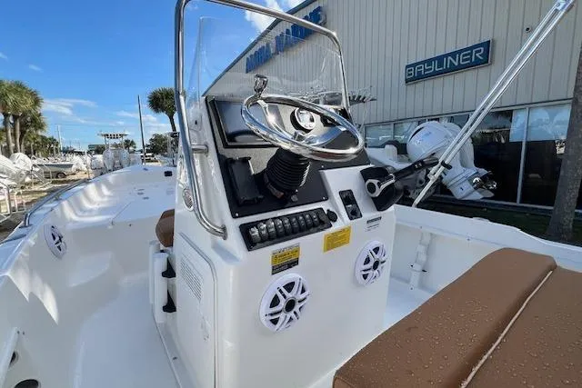 Slide: The Image of 2026 Key West 1720 Center Console boat with steering wheel and controls, docked near dealership. - 4