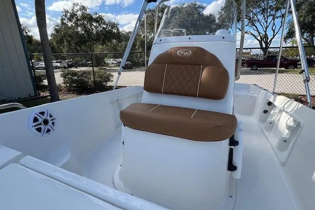 Slide: The Image of 2026 Key West 1720 Center Console boat with brown seating, outdoor setting. - 5