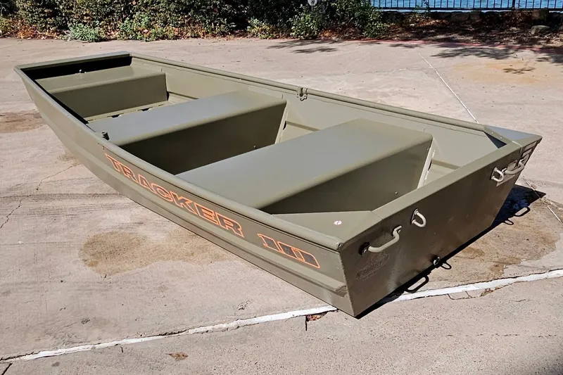 The Image of 2026 Tracker Grizzly 10 Jon boat on concrete surface, showcasing durable design. - 0