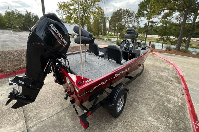 Slide: The Image of 2026 Tracker Bass Tracker Classic XL boat with Mercury engine, parked on a concrete surface. - 3