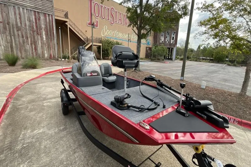 Slide: The Image of 2026 Tracker Bass Tracker Classic XL boat parked outside a sporting goods store. - 5