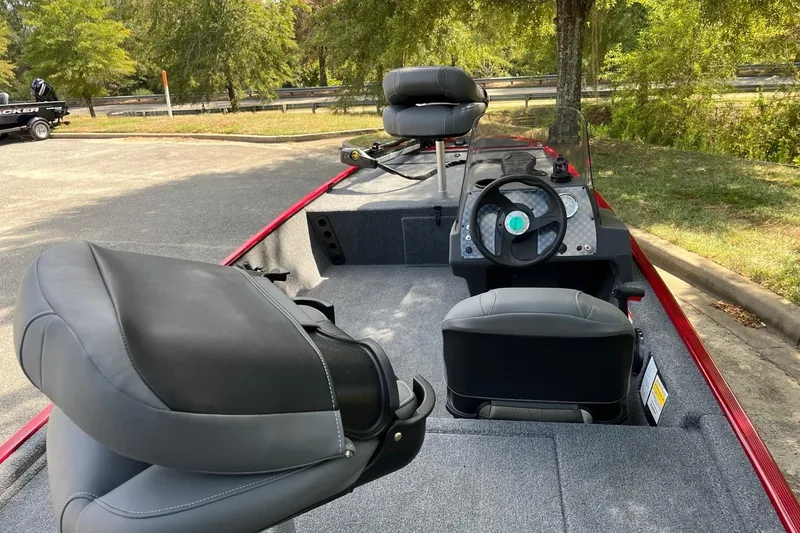 Slide: The Image of 2026 Tracker Bass Tracker Classic XL boat interior with steering wheel and seating. - 4