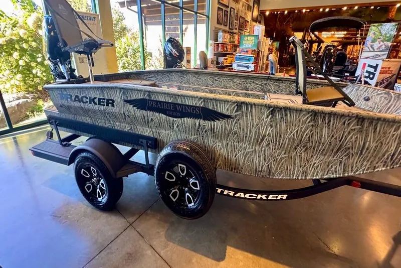 The Image of 2026 Tracker Grizzly 1650 T Prairie Wings Edition boat on display indoors. - 0