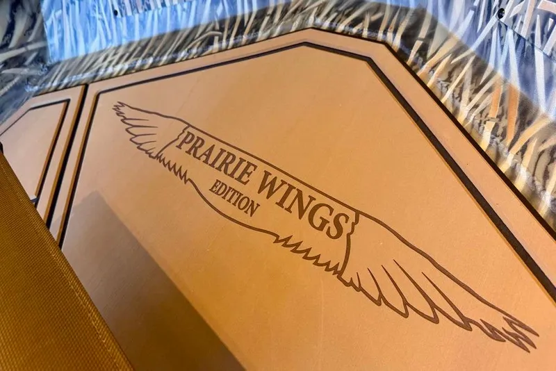 Slide: The Image of 2026 Tracker Grizzly 1650 T Prairie Wings Edition logo with wing design. - 5