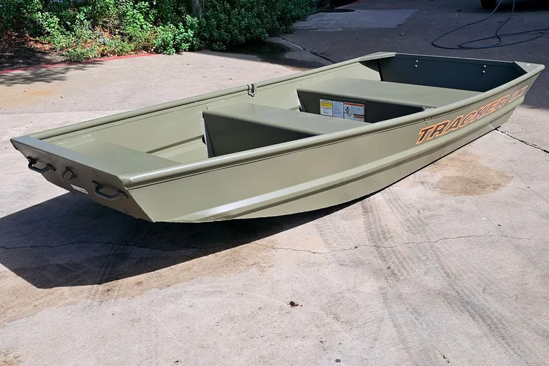 The Image of 2026 Tracker Grizzly 10 Jon boat on concrete surface, showcasing its sturdy design. - 0