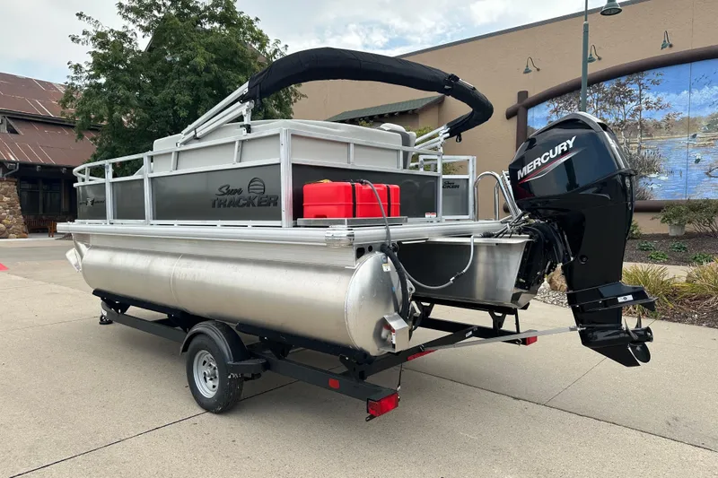 Slide: The Image of 2026 Sun Tracker Bass Buggy 16 XL Select pontoon boat with Mercury outboard motor. - 2