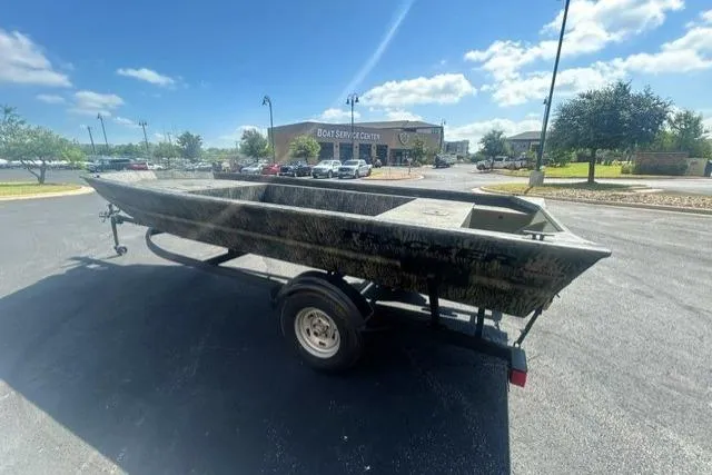 Slide: The Image of 2026 Tracker Grizzly 1754 Utility boat on trailer in parking lot. - 3