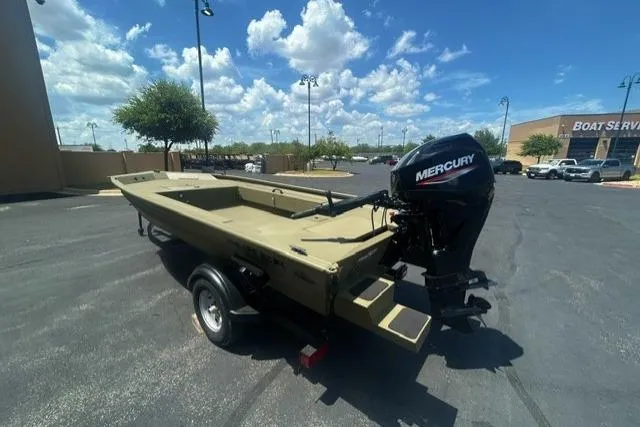 Slide: The Image of 2026 Tracker Grizzly 1654 T Sportsman boat with Mercury engine in parking lot. - 3
