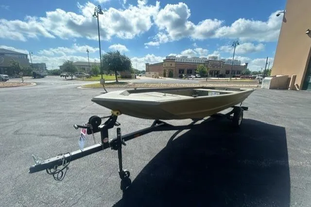 Slide: The Image of 2026 Tracker Grizzly 1648 Utility boat on trailer under a bright blue sky. - 2