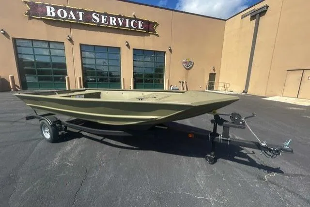 The Image of 2026 Tracker Grizzly 1648 Utility boat on trailer outside boat service center. - 0