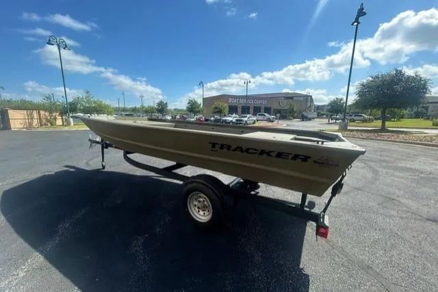 Slide: The Image of 2026 Tracker Grizzly 1648 Utility boat on trailer in sunny parking lot. - 3