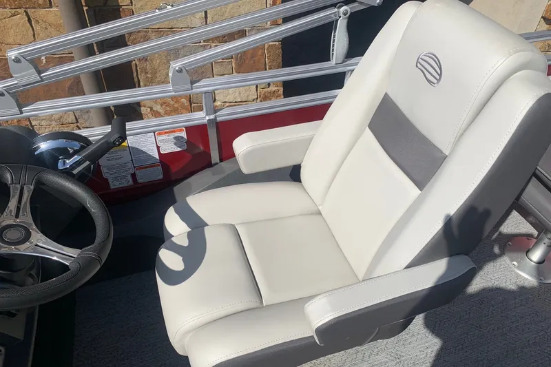 Slide: The Image of 2026 Sun Tracker Fishin' Barge 22 DLX captain's chair and steering wheel detail. - 8