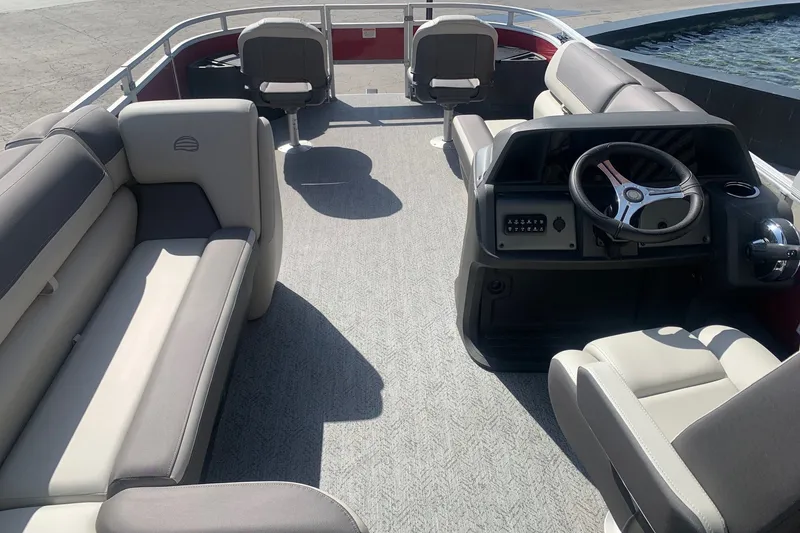 Slide: The Image of Interior view of 2026 Sun Tracker Fishin' Barge 22 DLX pontoon boat with seating and steering console. - 10