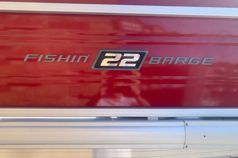 Slide: The Image of 2026 Sun Tracker Fishin' Barge 22 DLX, red exterior with model name displayed. - 4