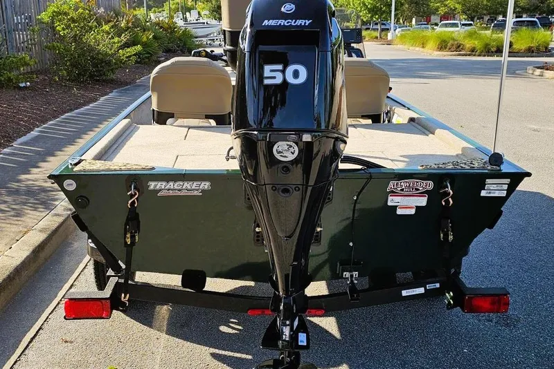 Slide: The Image of 2026 Tracker Bass Tracker Classic Limited boat with Mercury 50 engine, parked outdoors. - 3