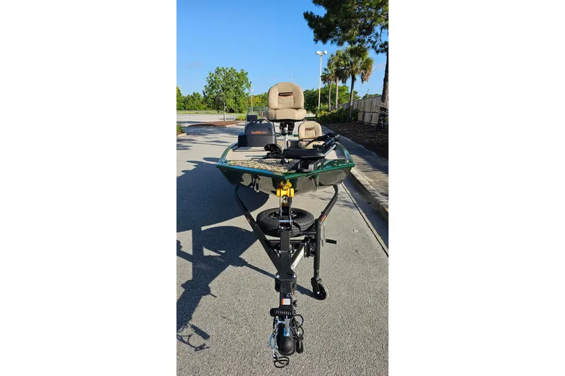 Slide: The Image of 2026 Tracker Bass Tracker Classic Limited boat on trailer, parked on sunny street. - 6