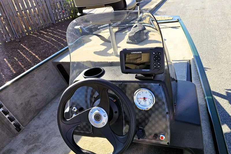 Slide: The Image of 2026 Tracker Bass Tracker Classic Limited dashboard with steering wheel and Lowrance fish finder. - 8