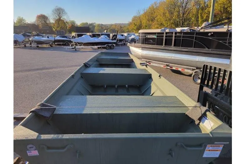 Slide: The Image of 2024 Polar Kraft 1436 Jon Boat with trailer, Yamaha 9.9 hp, parked outdoors. - 2