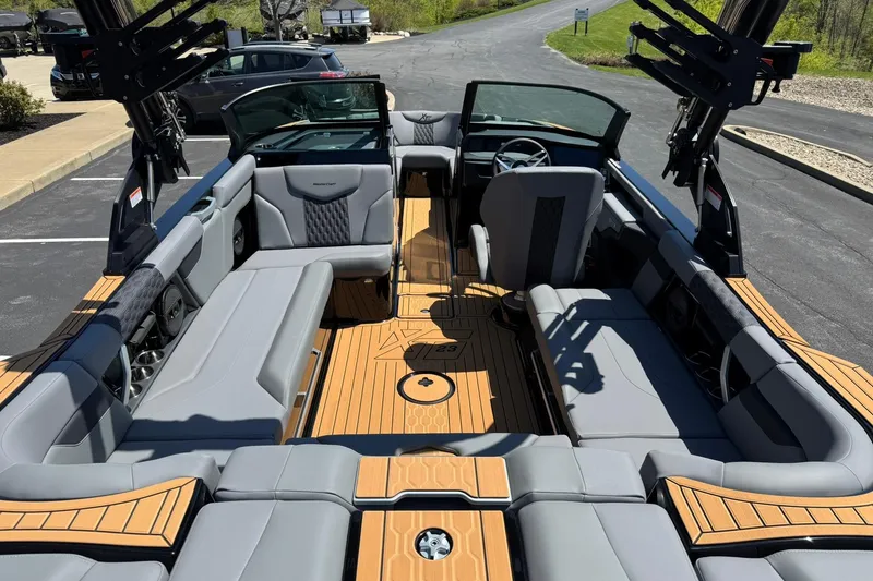 Slide: The Image of 2025 MasterCraft XT23 boat interior with sleek seating and modern design. - 12