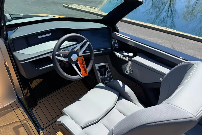 Slide: The Image of 2025 MasterCraft XT23 boat interior with modern steering and dashboard design. - 9