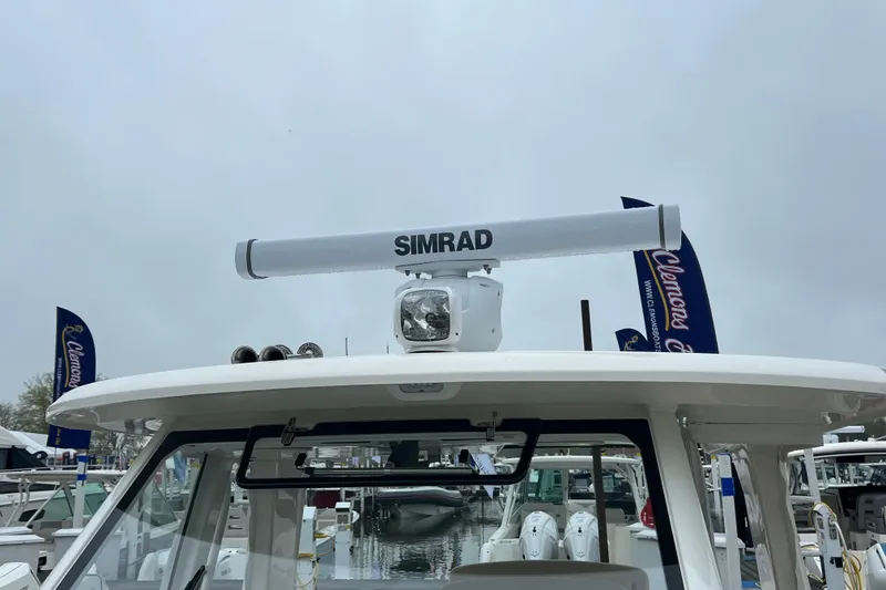 Slide: The Image of Boston Whaler 350 Realm 2026 with Simrad radar at a boat show. - 18