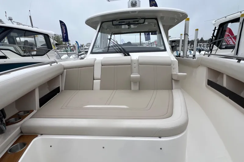 Slide: The Image of 2026 Boston Whaler 350 Realm boat interior with beige seating and modern design. - 20