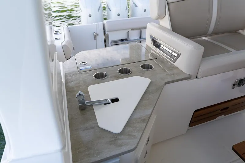 Slide: The Image of Manufacturer Provided Image: 2026 Boston Whaler 350 Realm boat interior with sleek countertop and built-in cup holders. - 6