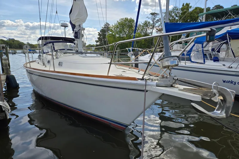 Slide: The Image of 1989 Pearson 37-2 sailboat docked, featuring sleek design and polished wood accents. - 0