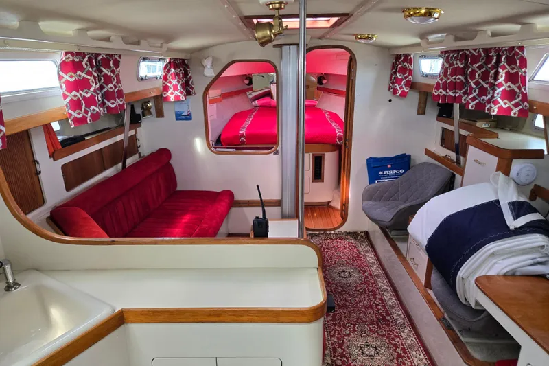 Slide: The Image of Interior of 1989 Pearson 37-2 sailboat with red upholstery and nautical decor. - 10