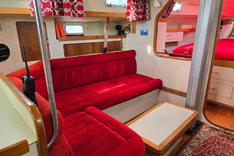 Slide: The Image of Interior of 1989 Pearson 37-2 sailboat with red upholstery and wooden accents. - 11