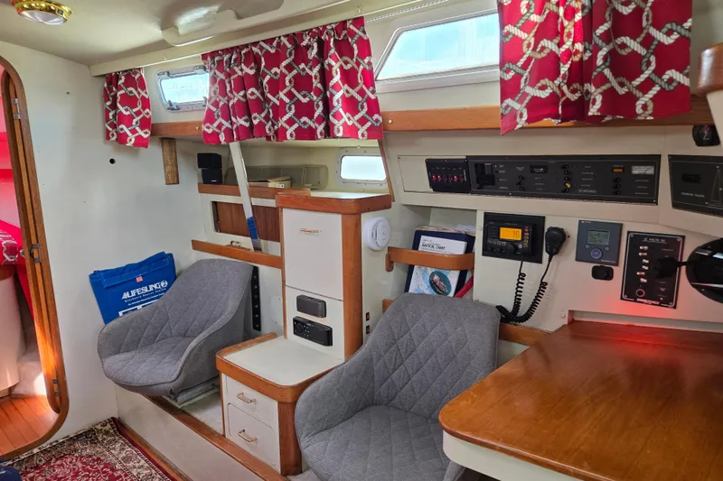Slide: The Image of Interior of 1989 Pearson 37-2 sailboat with navigation station and seating area. - 13