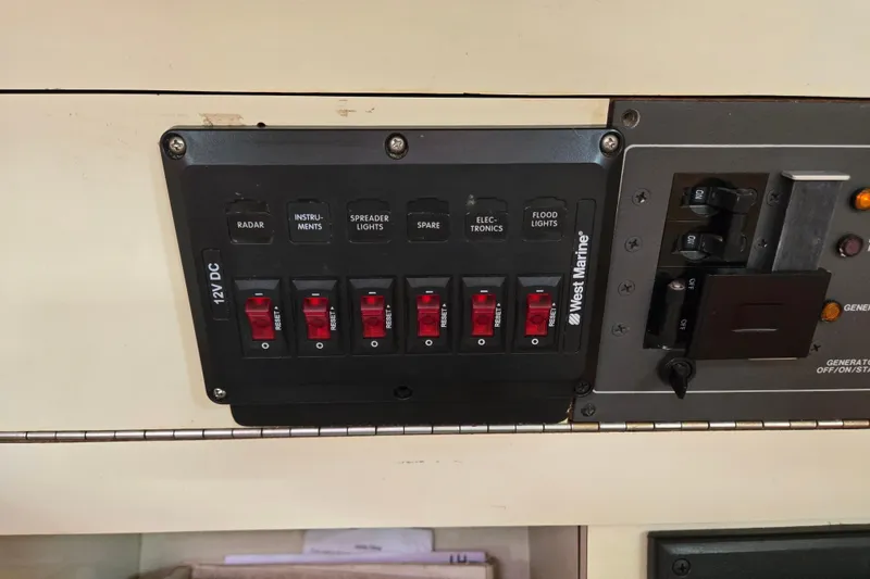 Slide: The Image of Control panel on a 1989 Pearson 37-2 sailboat with labeled switches and circuit breakers. - 17