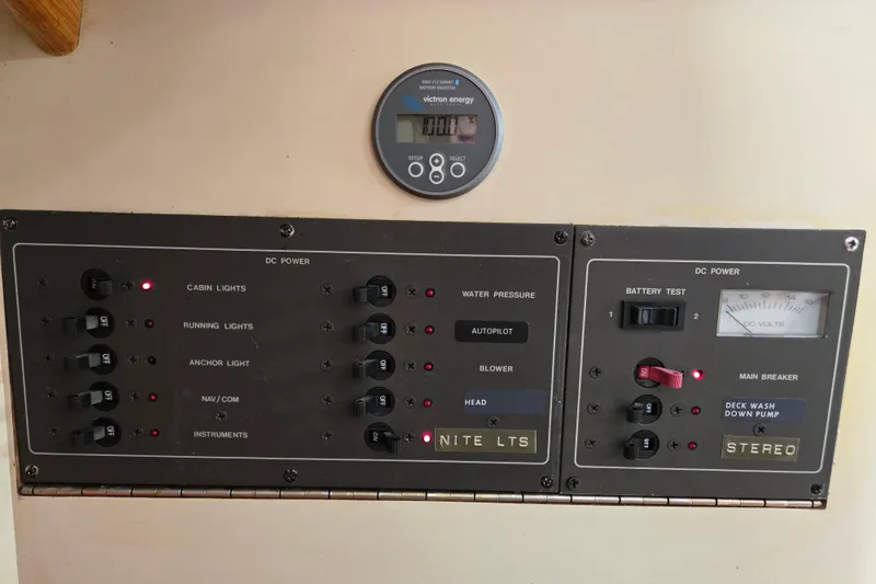 Slide: The Image of Electrical control panel on a 1989 Pearson 37-2 sailboat, featuring various switches and gauges. - 19