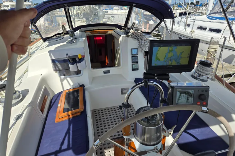 Slide: The Image of Cockpit of 1989 Pearson 37-2 sailboat with navigation equipment and blue seating. - 2