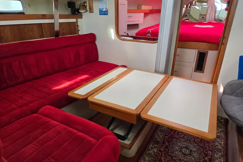 Slide: The Image of Interior of a 1989 Pearson 37-2 sailboat with red seating and foldable table. - 23