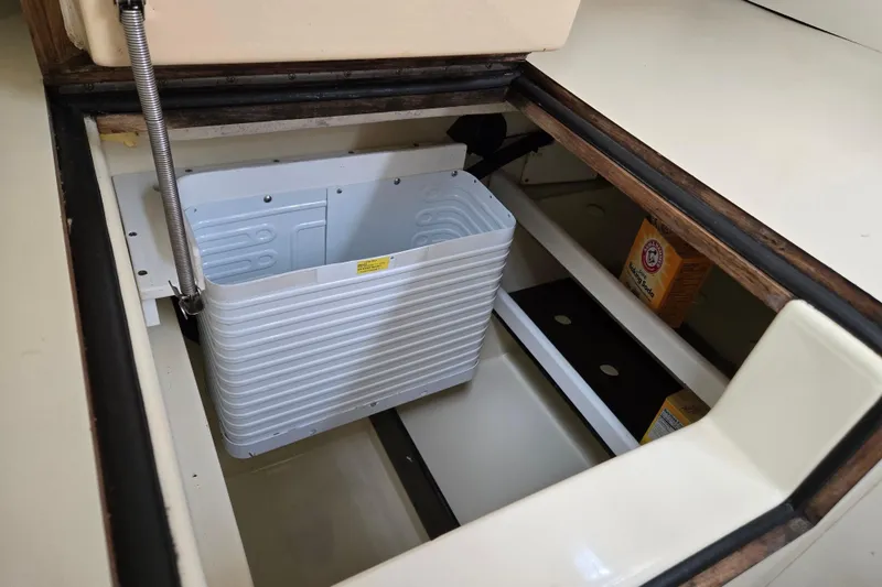 Slide: The Image of Interior storage compartment of a 1989 Pearson 37-2 boat with baking soda box. - 26