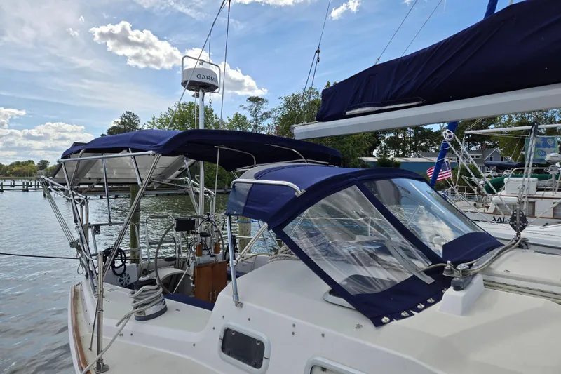Slide: The Image of Sailboat docked with blue canopy, Pearson 37-2, 1989 model, clear sky background. - 3