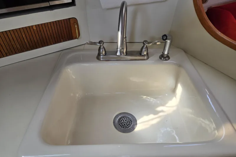 Slide: The Image of Cream-colored sink with chrome faucet in 1989 Pearson 37-2 yacht interior. - 30