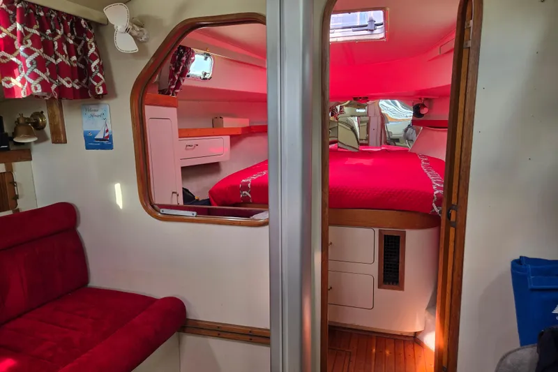 Slide: The Image of Interior of 1989 Pearson 37-2 sailboat with red upholstery and cozy cabin. - 31