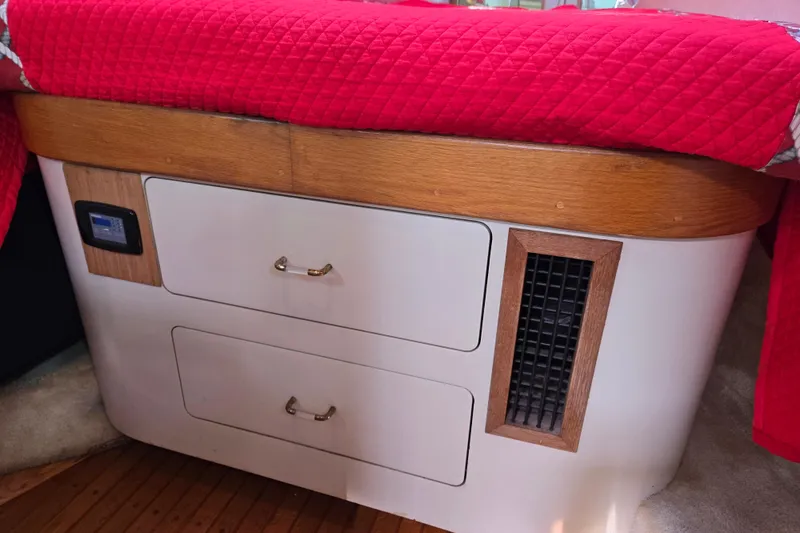 Slide: The Image of Interior of 1989 Pearson 37-2 sailboat with red bedding and storage drawers. - 33