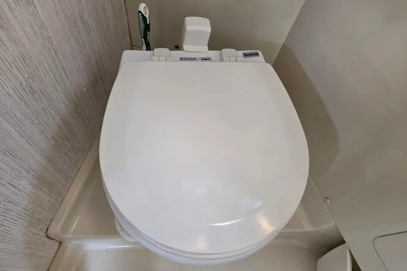 Slide: The Image of White marine toilet in a 1989 Pearson 37-2 yacht bathroom. - 37