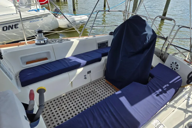 Slide: The Image of 1989 Pearson 37-2 sailboat cockpit with blue cushions and covered helm at dock. - 4
