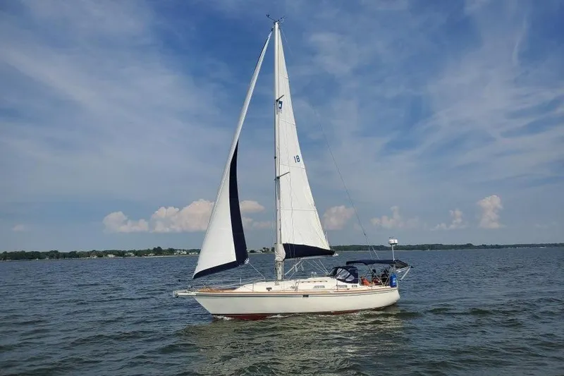 Slide: The Image of Sailboat Pearson 37-2 (1989) cruising on a calm lake under a clear blue sky. - 42