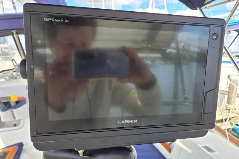 Slide: The Image of Garmin GPSMAP X5 on 1989 Pearson 37-2 sailboat, docked with visible reflections. - 8